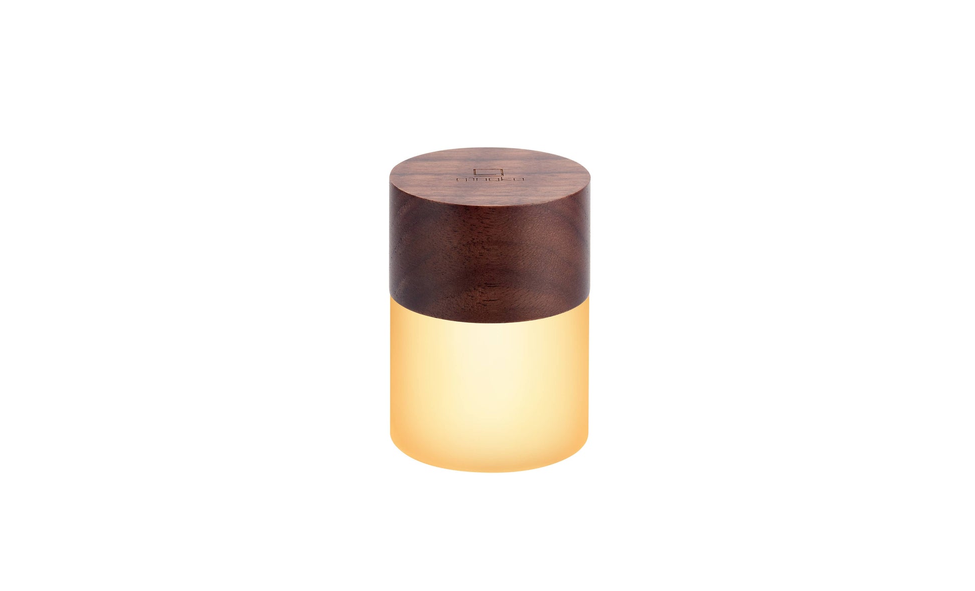 Lemelia mini light with walnut top glowing warm white on white background