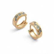 Fable forget-me-not gold hoop earrings, pair angled on white background