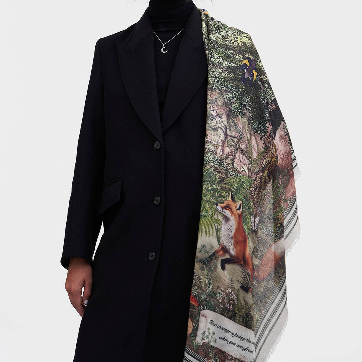 Woodland scarf worn open as a wrap over a long black coat