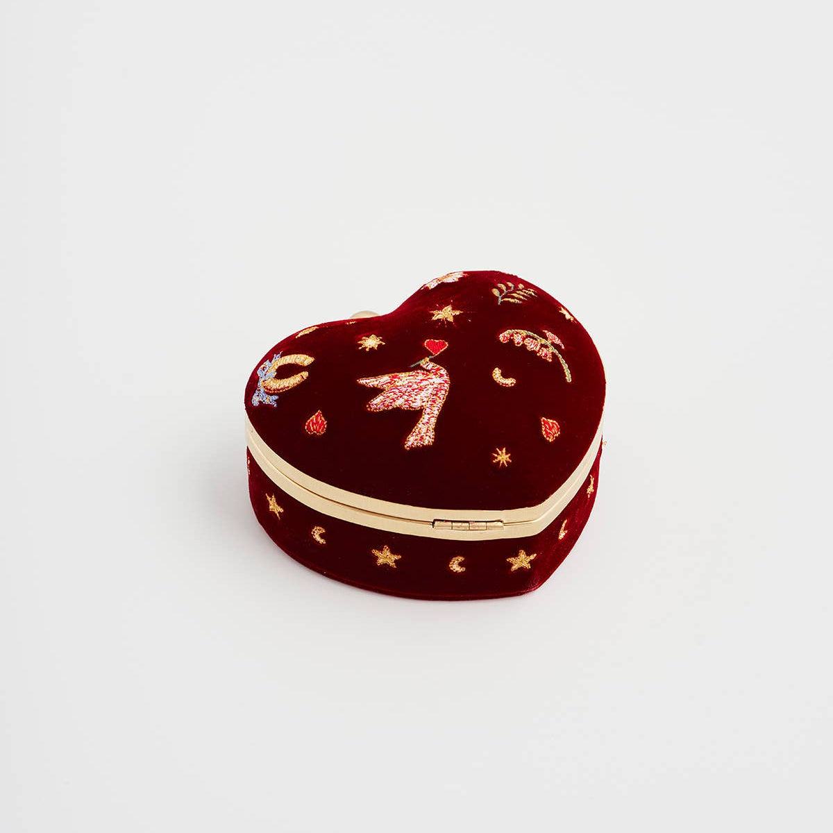 Side view of the heart jewellery box with its gold trim and clasp