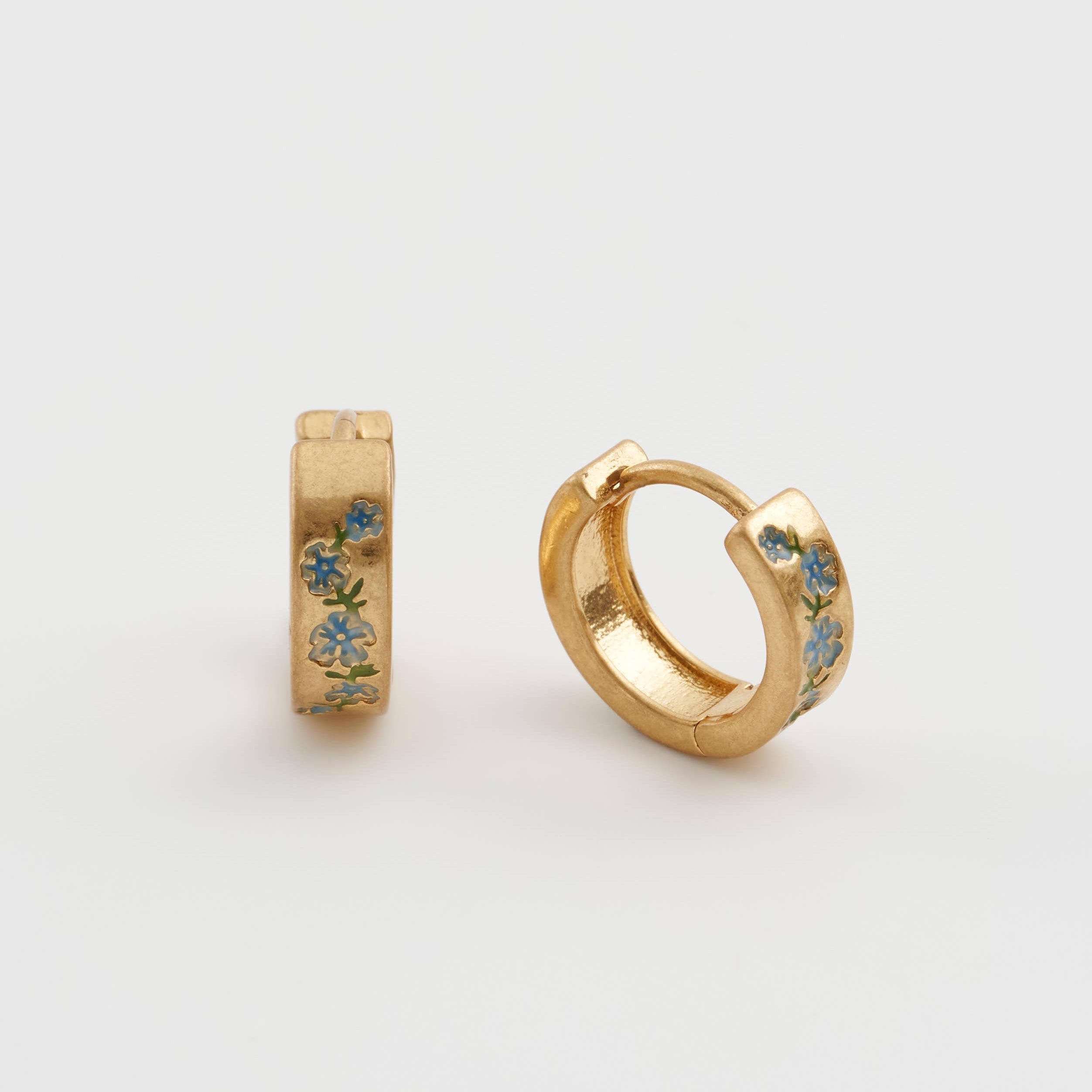 Forget-me-not hoop earrings pair, one upright one angled, white background