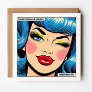 Square pop art card of a winking woman with blue hair and red lips