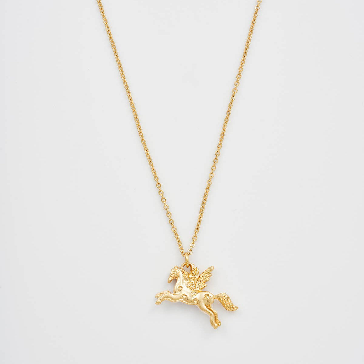 Pegasus pendant hanging from a fine worn gold-plated chain