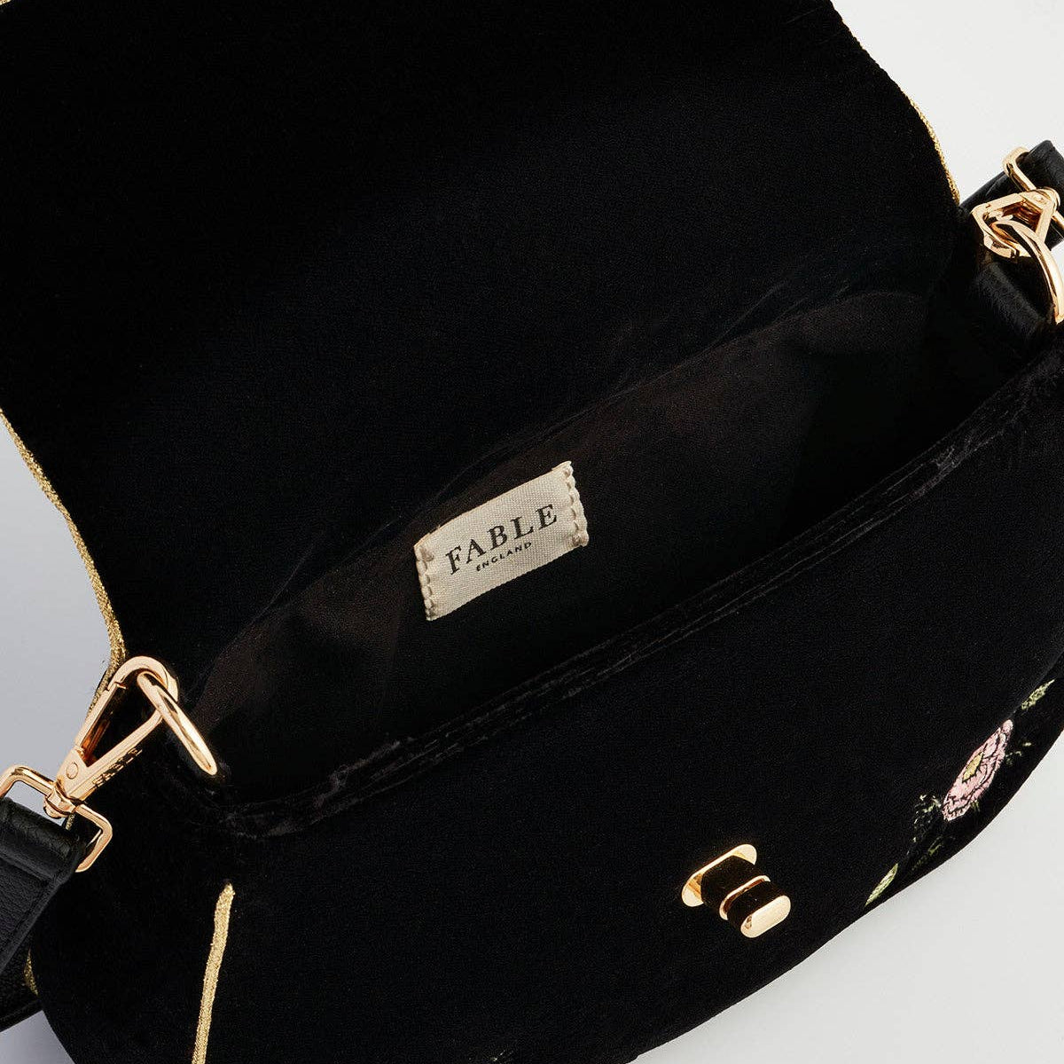 Rose embroidered clutch open showing Fable England label inside