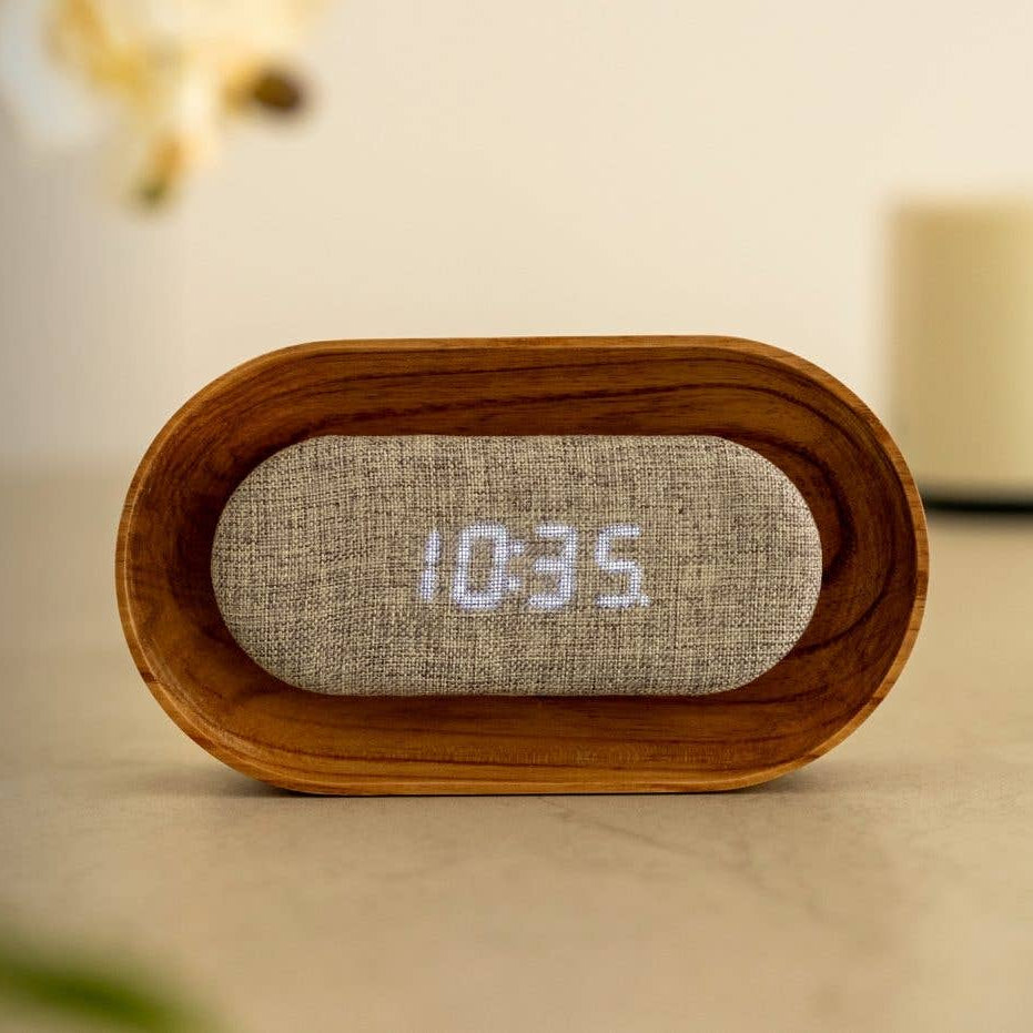 Lumos walnut clock unlit showing linen face on white shelf