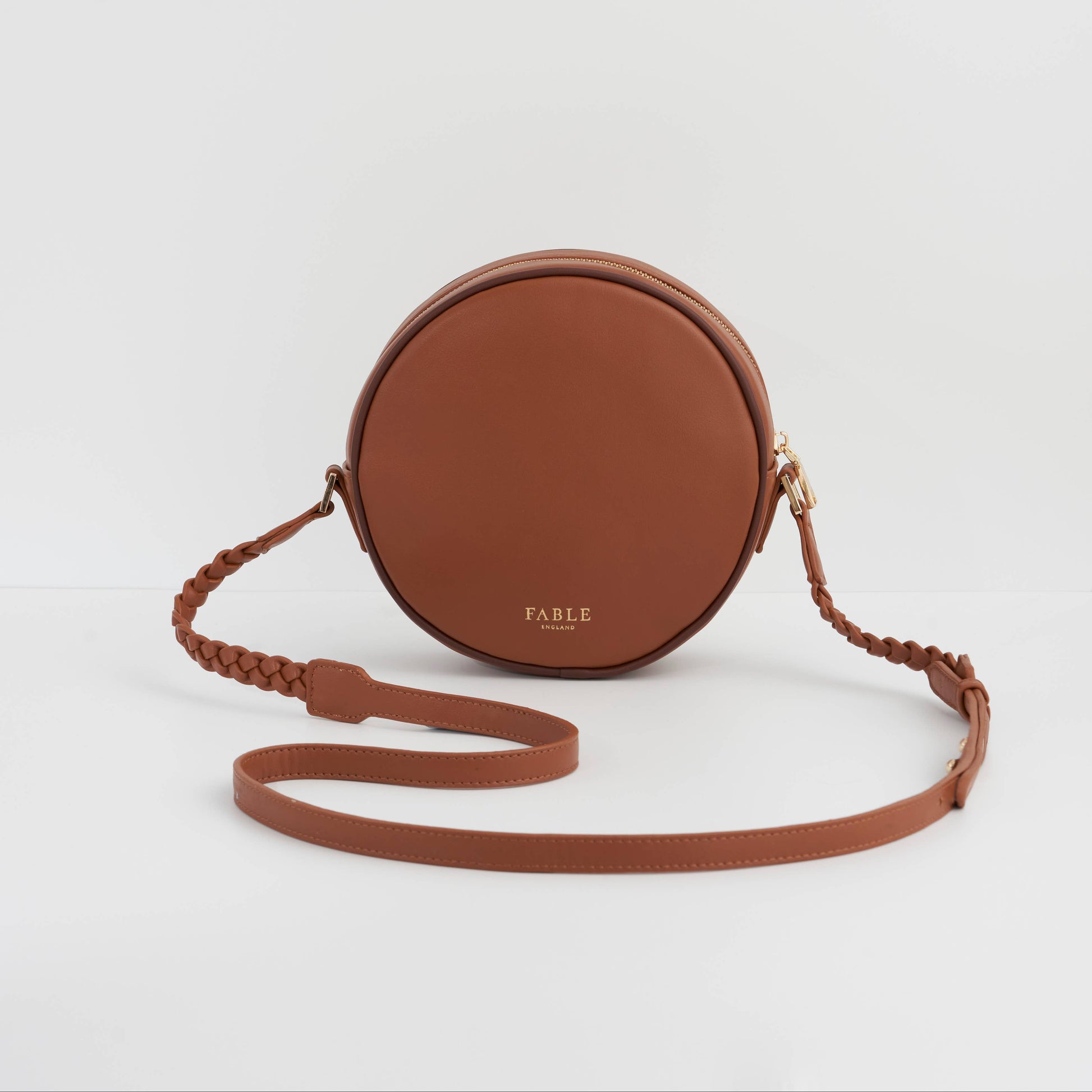 Back of the tan circle purse, plain leather with a Fable stamp