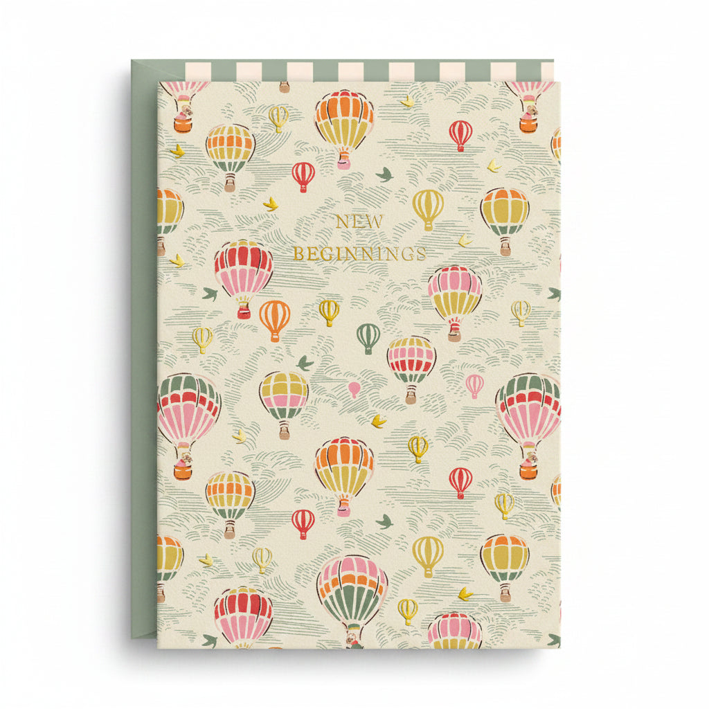 Cream card patterned with colourful hot air balloons and gold foil lettering