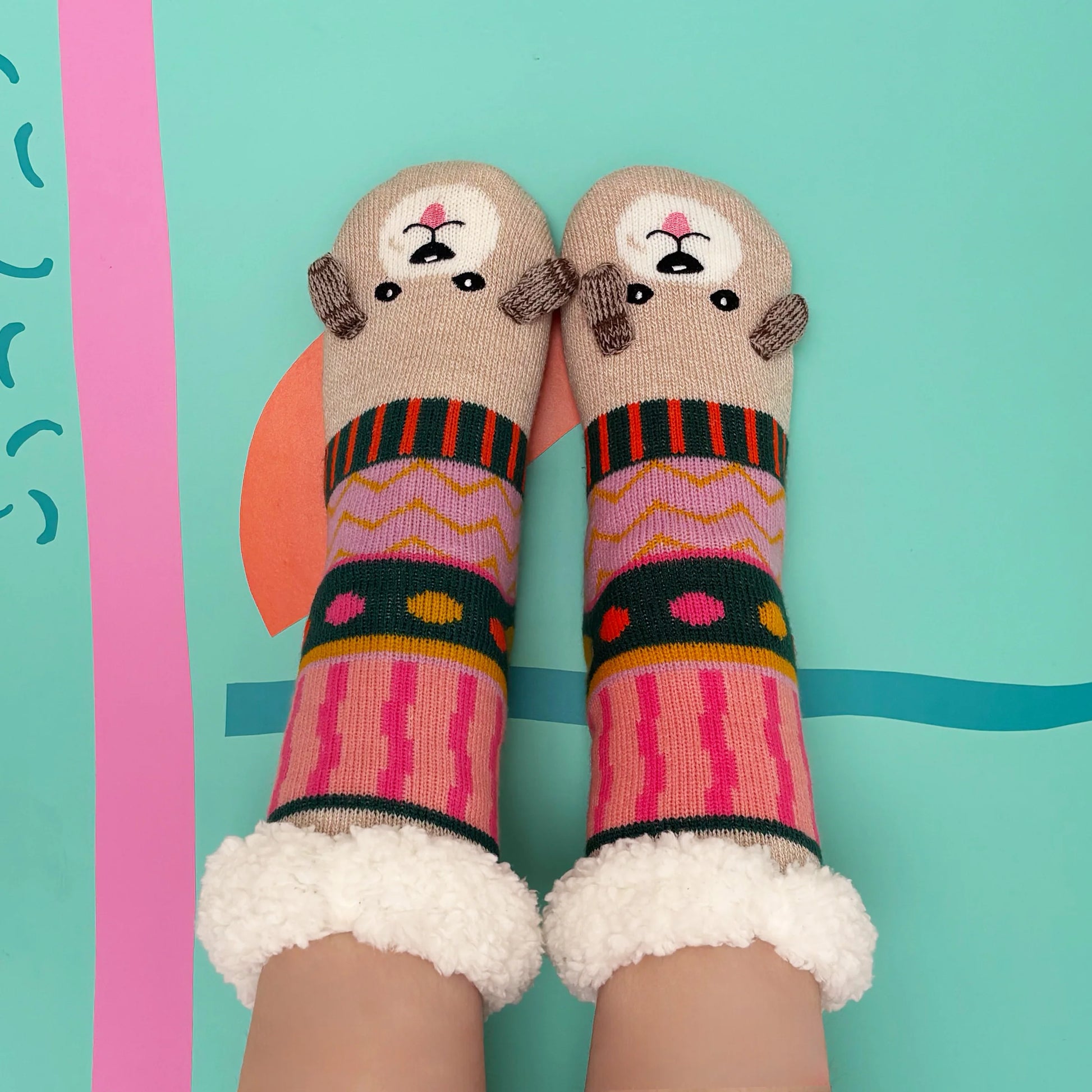 Overhead shot of fluffy cuff socks with dog face toes.
