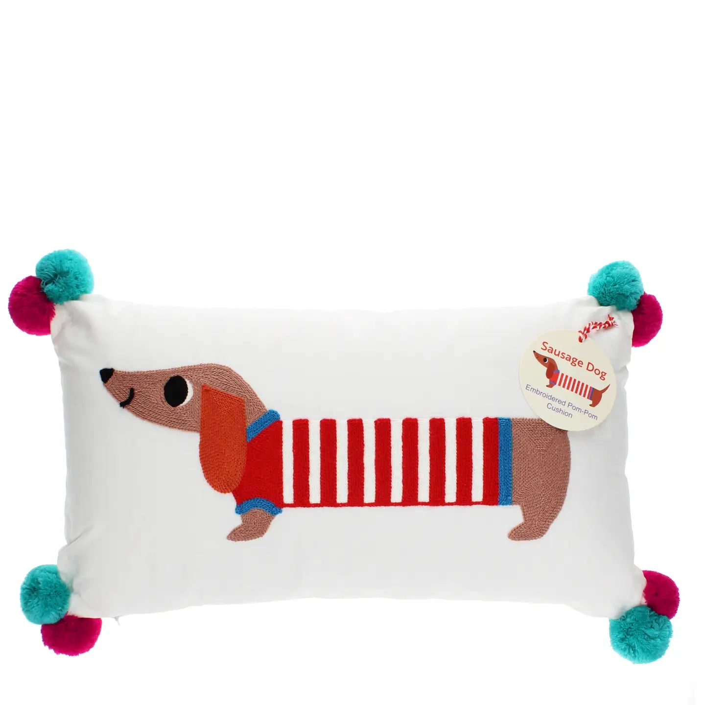 White oblong embroidered cushion with sausage dog design and red and blue pom poms on corners.