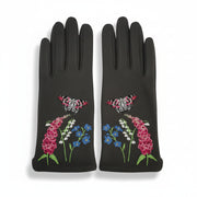 Flat lay of both gloves with vivid floral and butterfly embroidery on the outer side, including pink foxgloves, lily of the valley, cornflowers, and two pink butterflies.