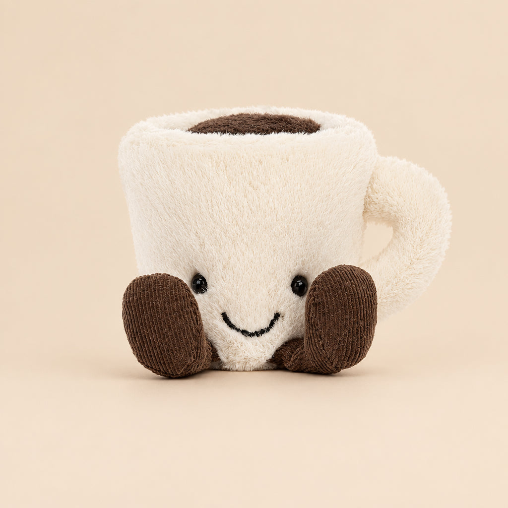 Front view of the Jellycat Amuseable Espresso Cup showcases its adorable face, rich coffee filling, and charming cordy feet. A mini friend for coffee lovers and cuddle enthusiasts.