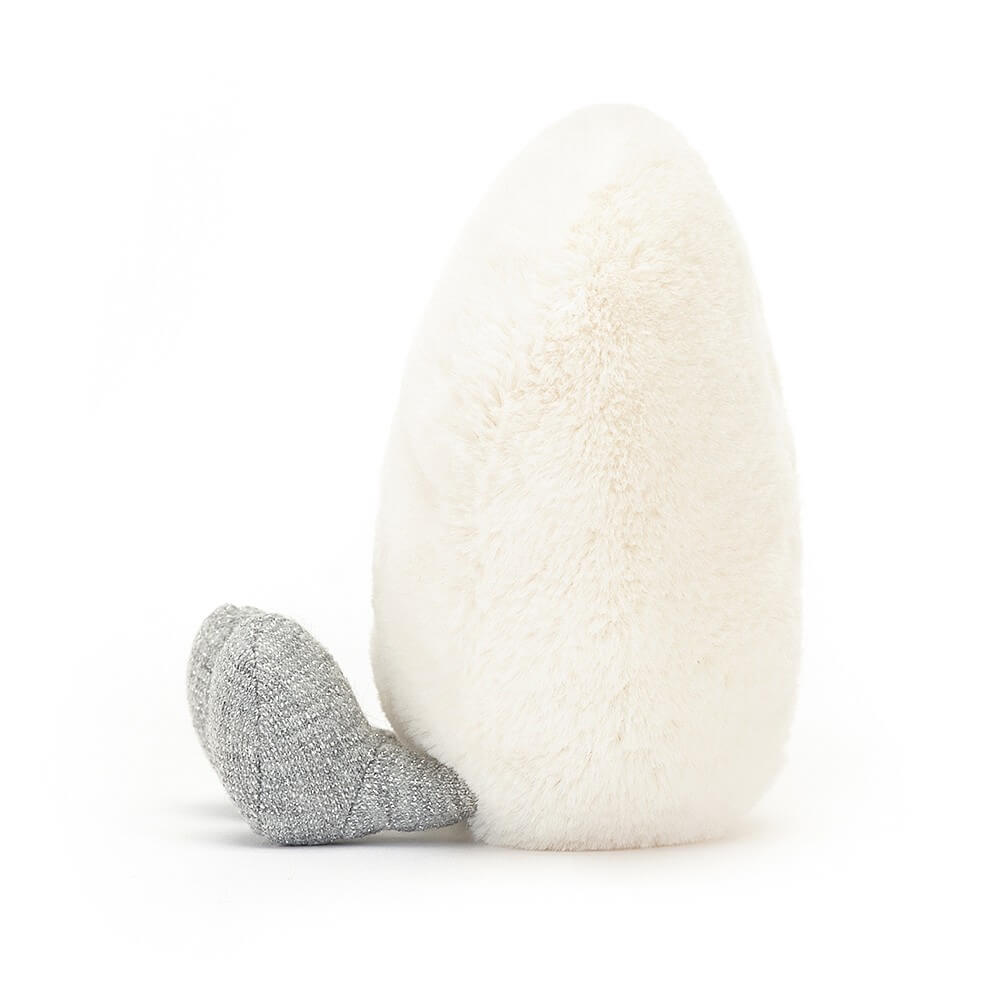 From the side Jellycat Amuseables Cream Heart children's soft toy sits with his legs stretched out in front.