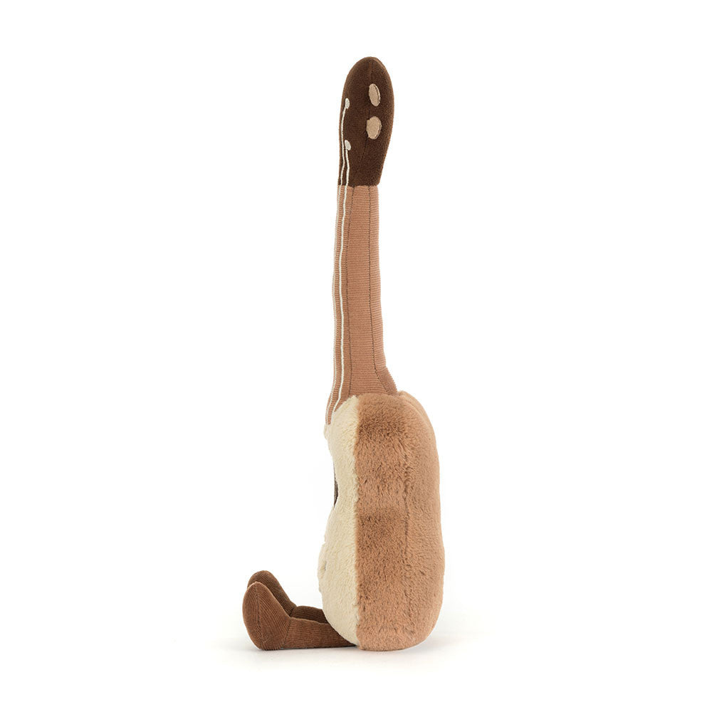 Side profile of Jellycat Amuseables Ukulele showing soft plush design and cordy legs.