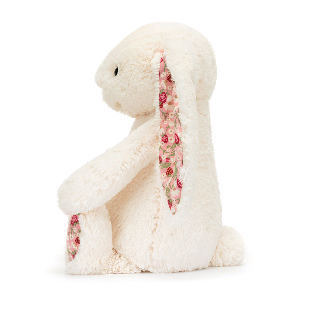 Side view of Jellycat Blossom Cream Bunny ‘Berry’, showing its soft body and adorable profile.