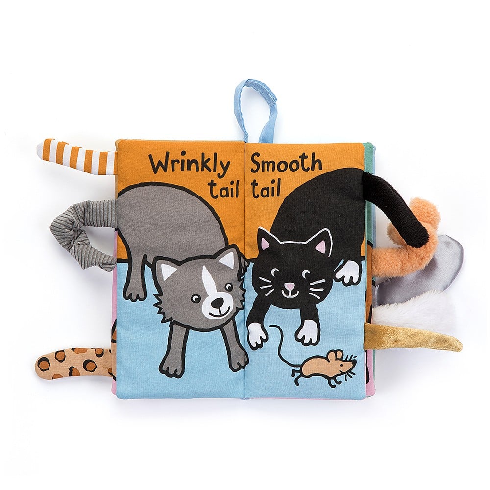  A single open page from the Jellycat Kitten Tails Activity Book, showcasing two playful cat illustrations with textured tails and other tactile elements like crinkles.