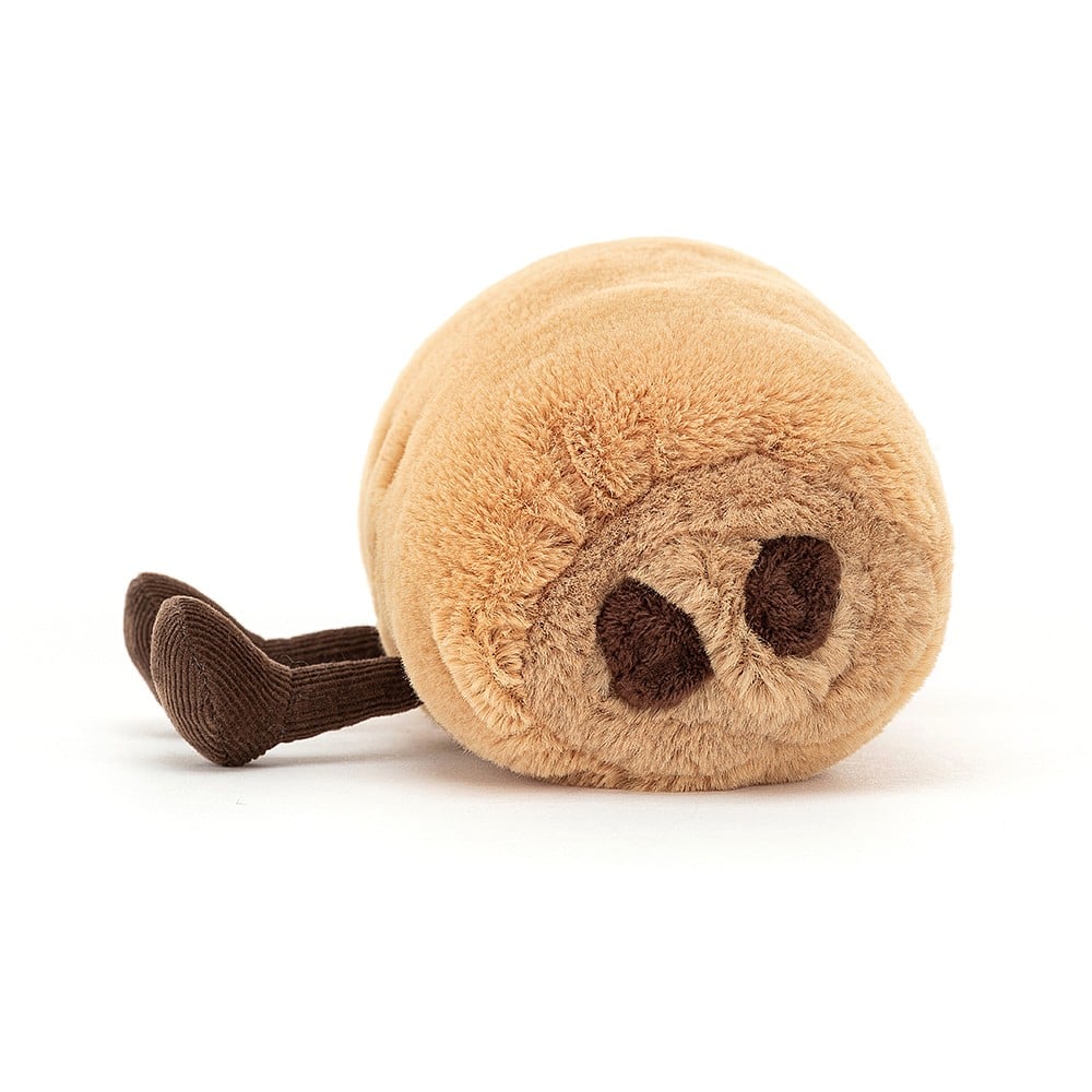 Side view: Pastry perfection in plush form! This fun Jellycat plush, Amuseable Pain Au Chocolat, features soft layers, rich chocolate filling, and comfy cordy boots.