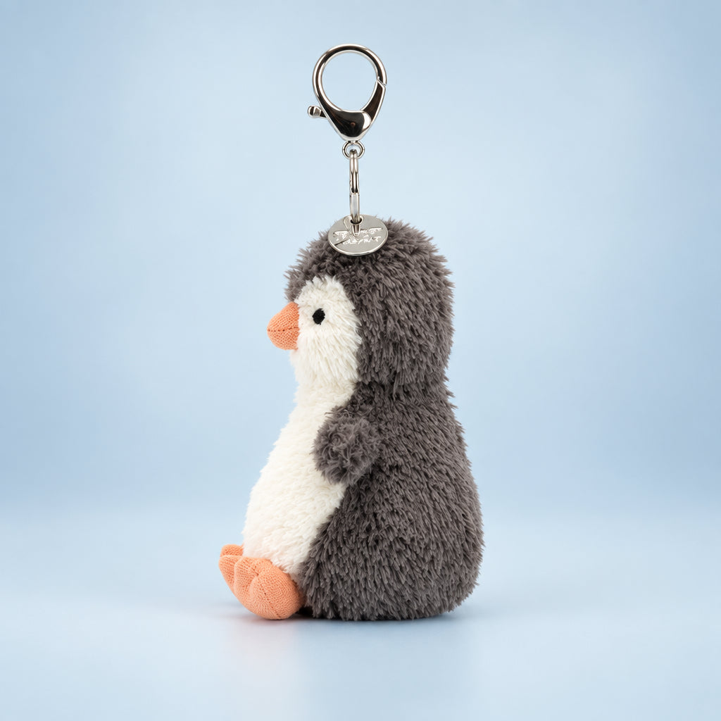 Side View: Clip-on cuteness! Jellycat Peanut Penguin Bag Charm (17 cm tall). This plush penguin keychain boasts soft fur, adorable details, and is the perfect bag accessory.