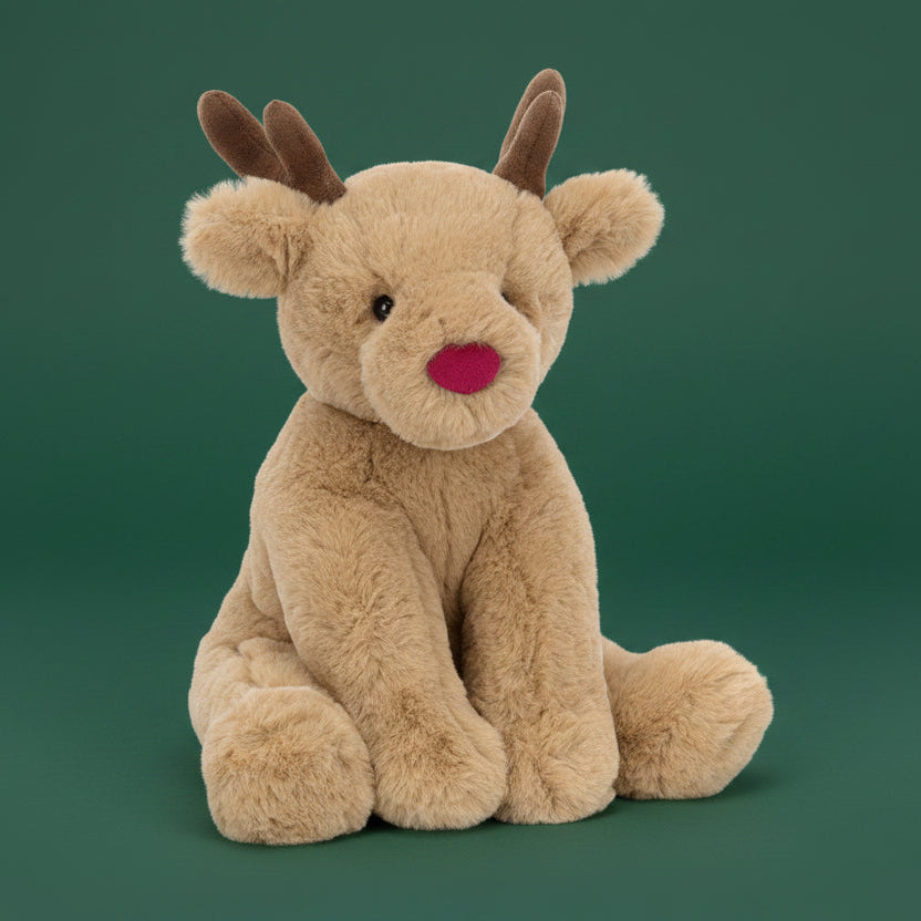 Plush reindeer toy with a red nose on a white background