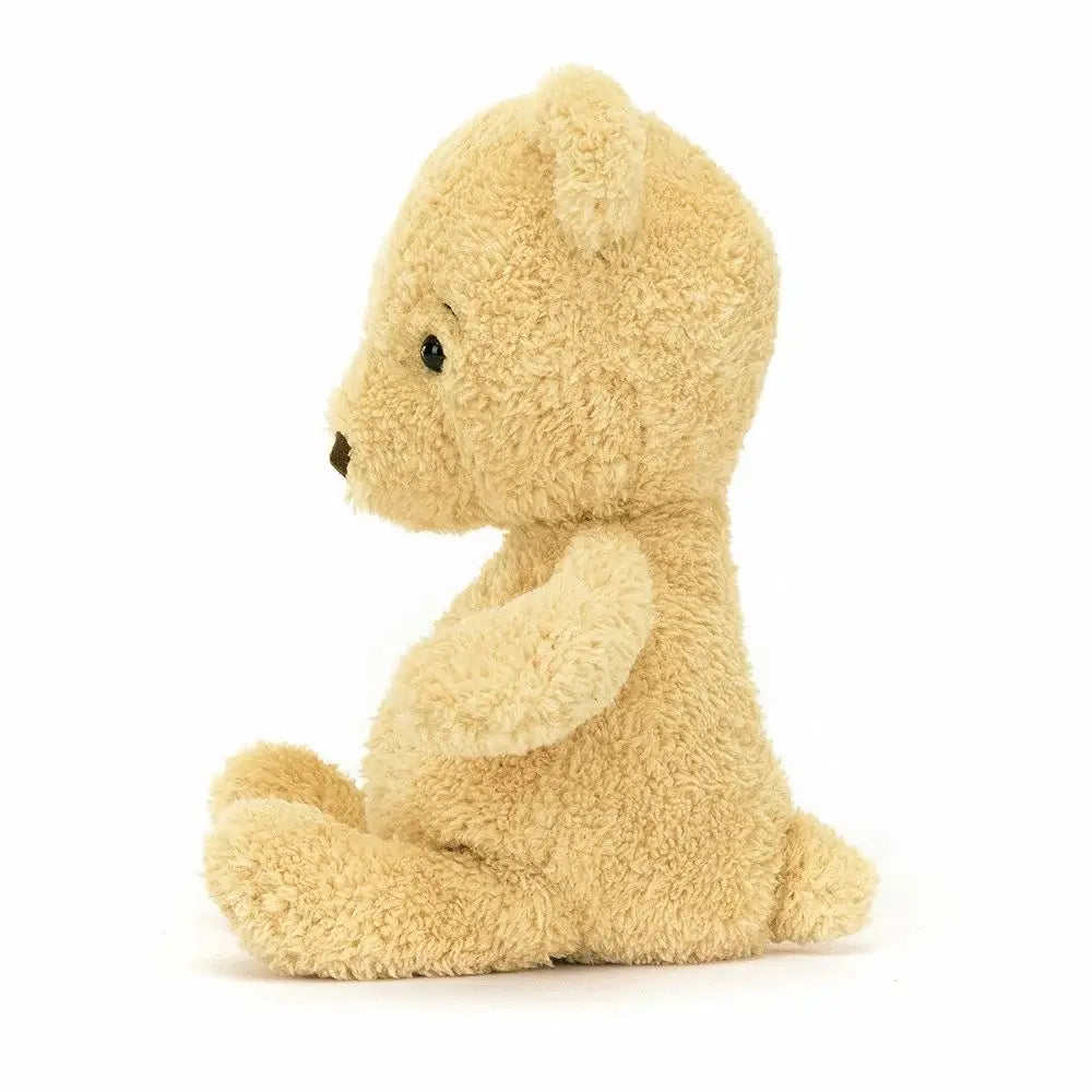 A close-up of the Jelycat Rumblikin Bear's face, highlighting its expressive eyes and cute nose.
