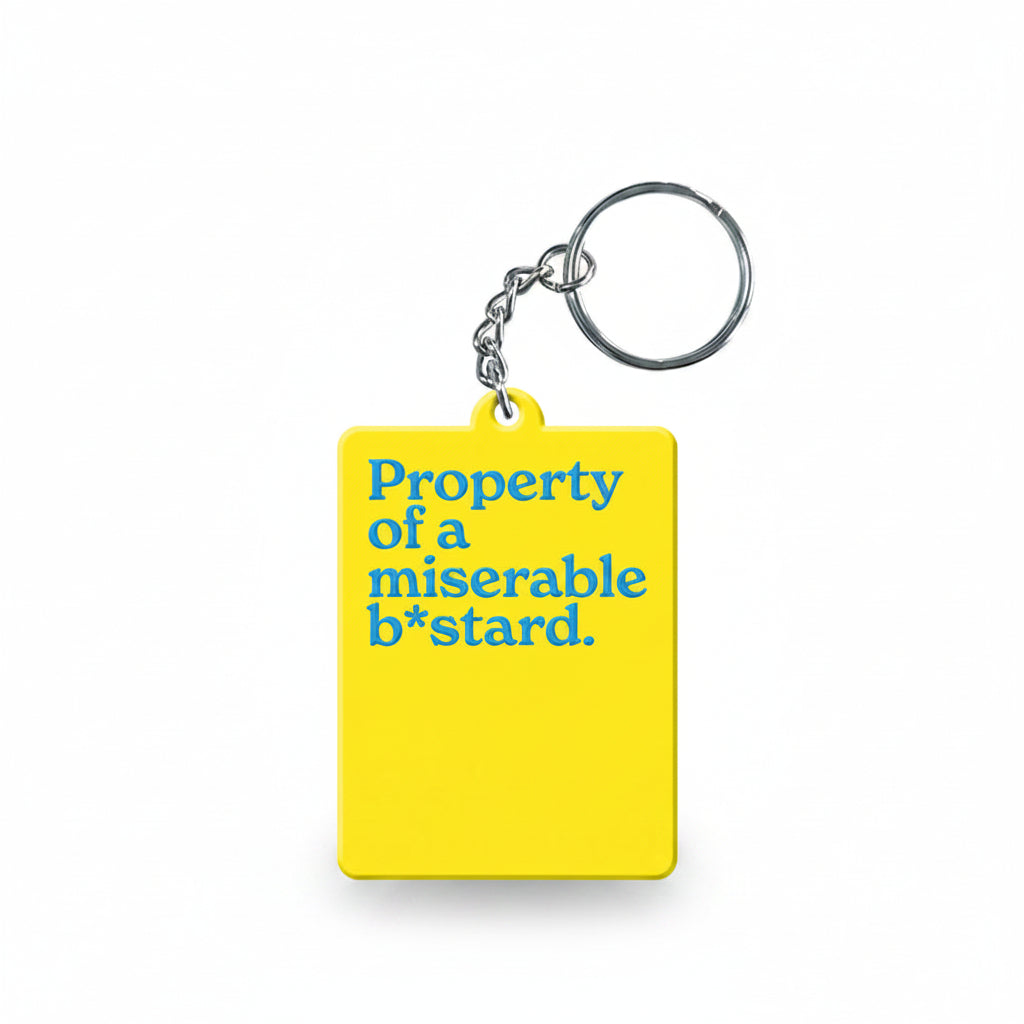 Yellow keyring reading property of a miserable b*stard