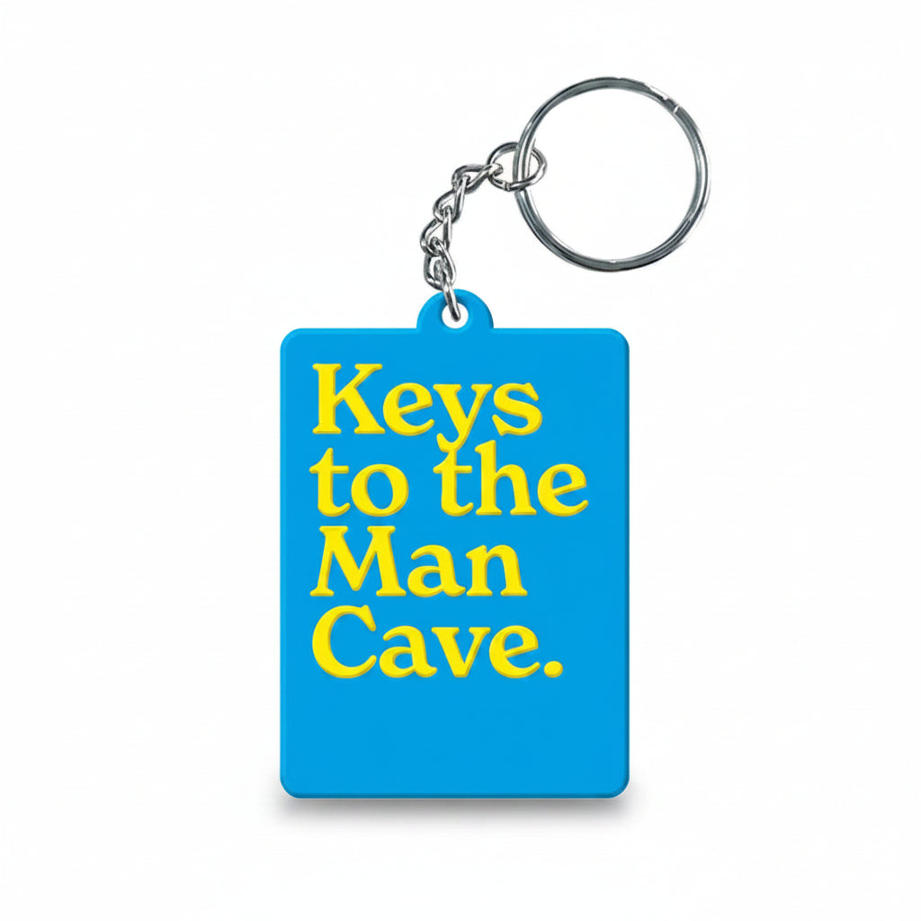 Blue keyring reading keys to the man cave in yellow type