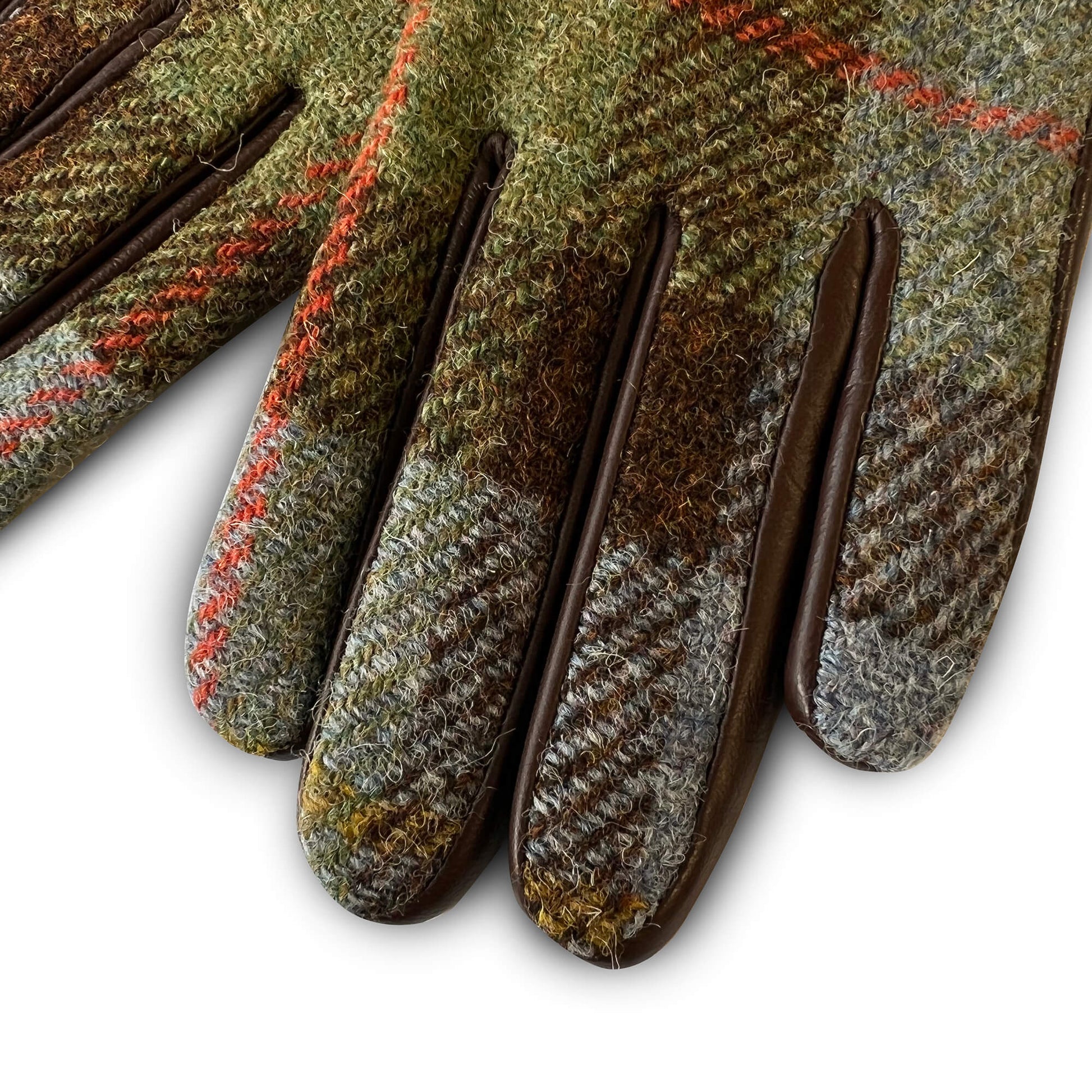 Close-up of glove fingers in green, blue and rust Harris Tweed®, showing fine wool texture and brown leather accents.