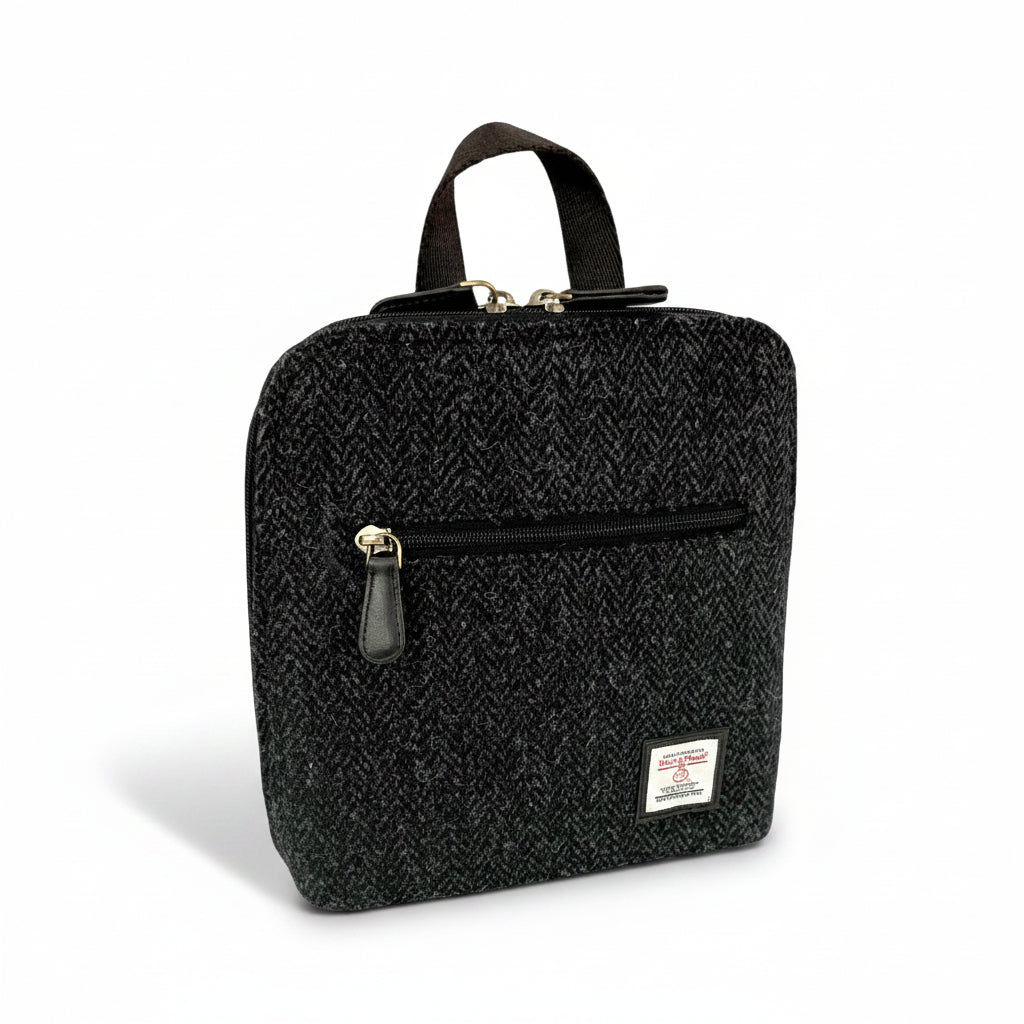 Charcoal Harris Tweed mini backpack front angled view on white background.