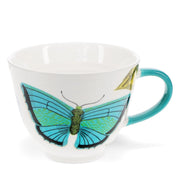 Large white mug with vivid blue butterfly illustration and blue handle.