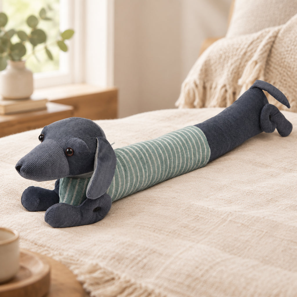Side view of Sausage Dog Draught Excluder in green jumper, polyester design for blocking cold air under doors.