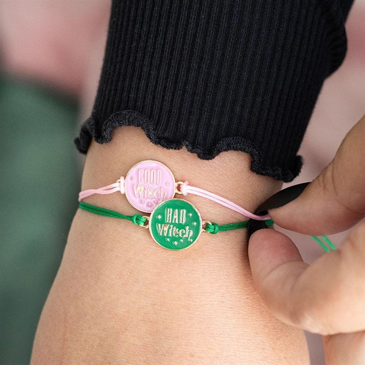 Good Witch and Bad Witch adjustable cord bracelets worn together on wrist.