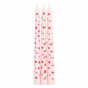 Three pink taper candles decorated with red hearts, standing upright on white background, ideal for romantic table settings or home décor.
