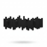 Umbra Sticks wall hook in black on concrete wall with bag and accessories