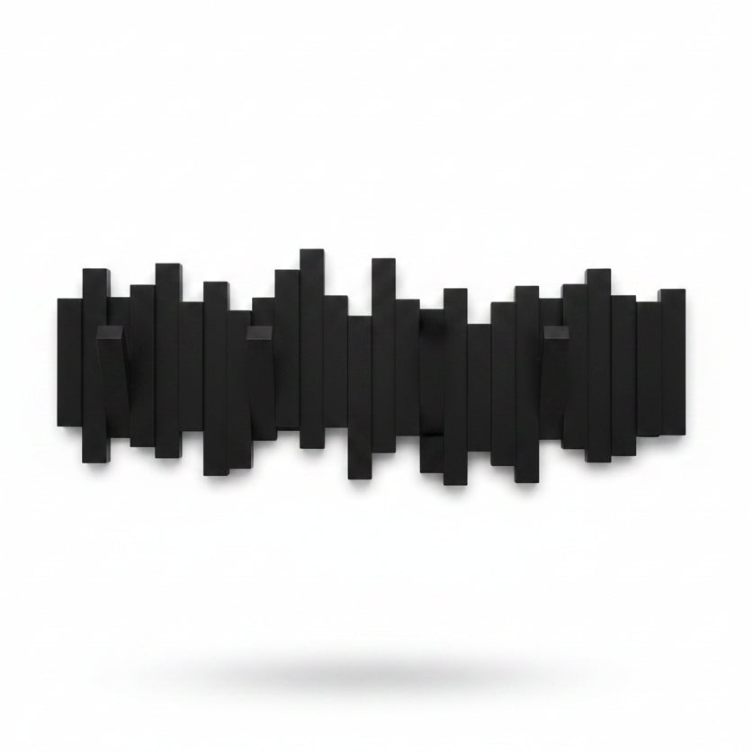 Umbra Sticks wall hook in black on concrete wall with bag and accessories