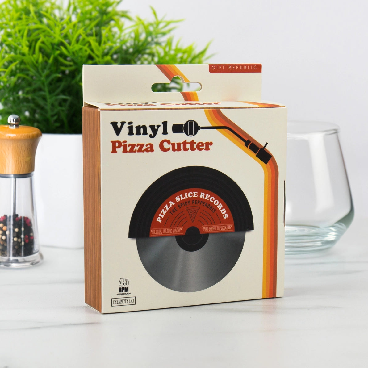 Front view of retro vinyl-style pizza cutter in packaging.
