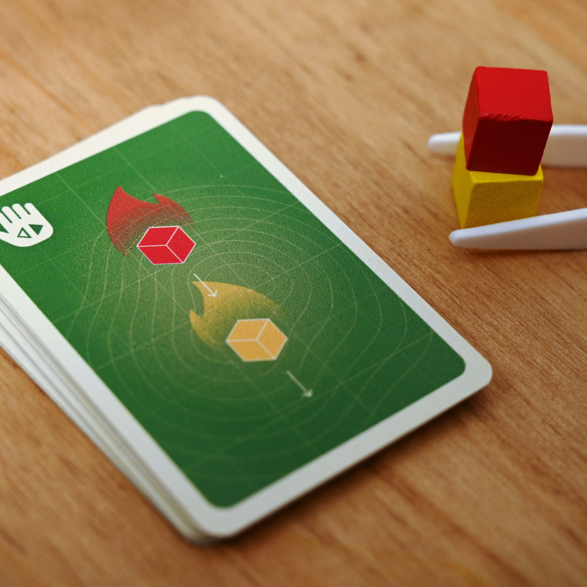 Tinderblox instruction cards with tweezers holding cinder cubes