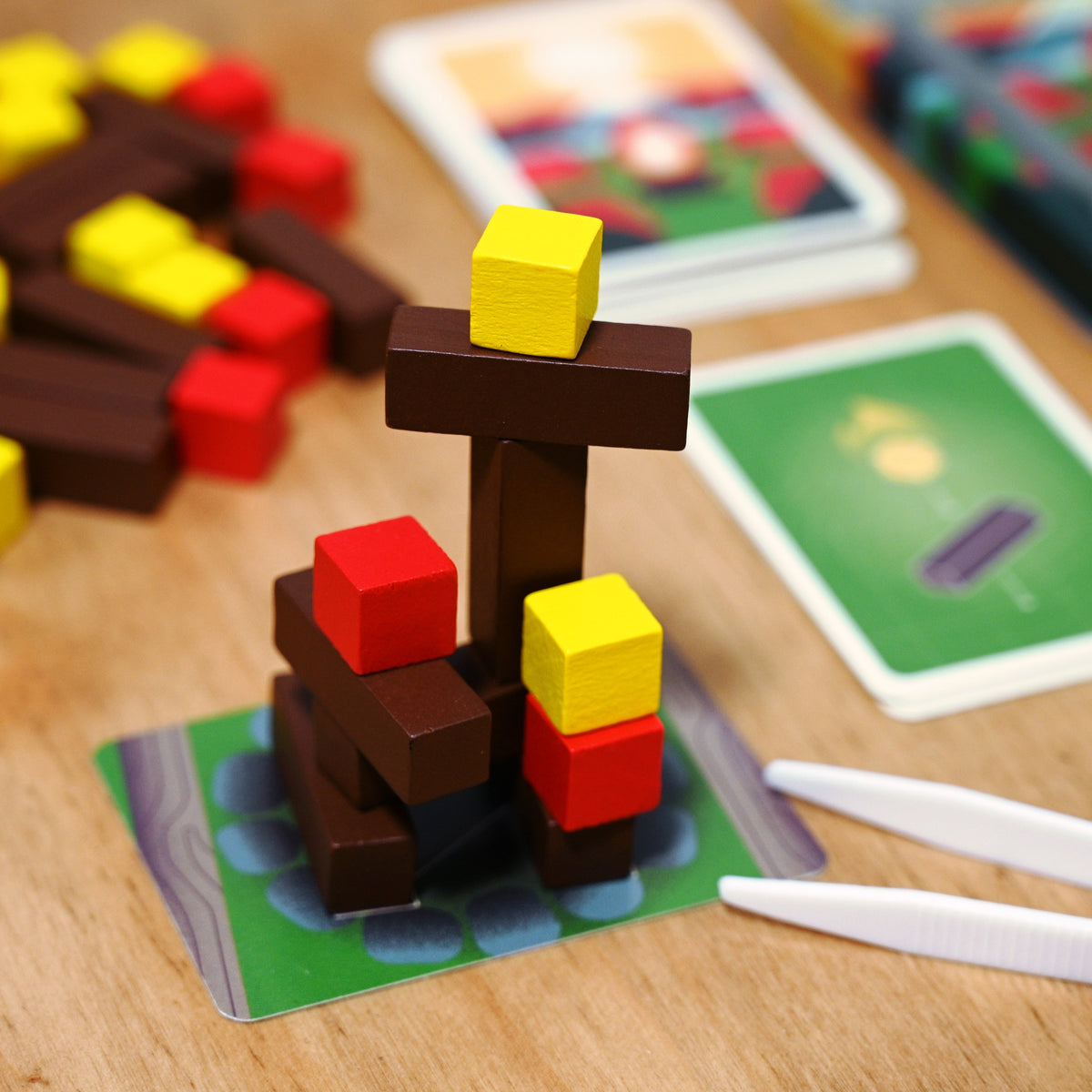 Tinderblox campfire of logs and cubes being built on a wooden table