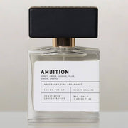 Ambition eau de parfum bottle with black cap, front view on cream background