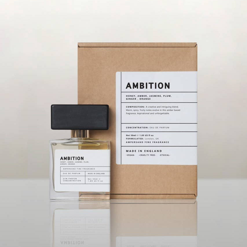 Ambition perfume bottle beside its recycled kraft gift box, cream background