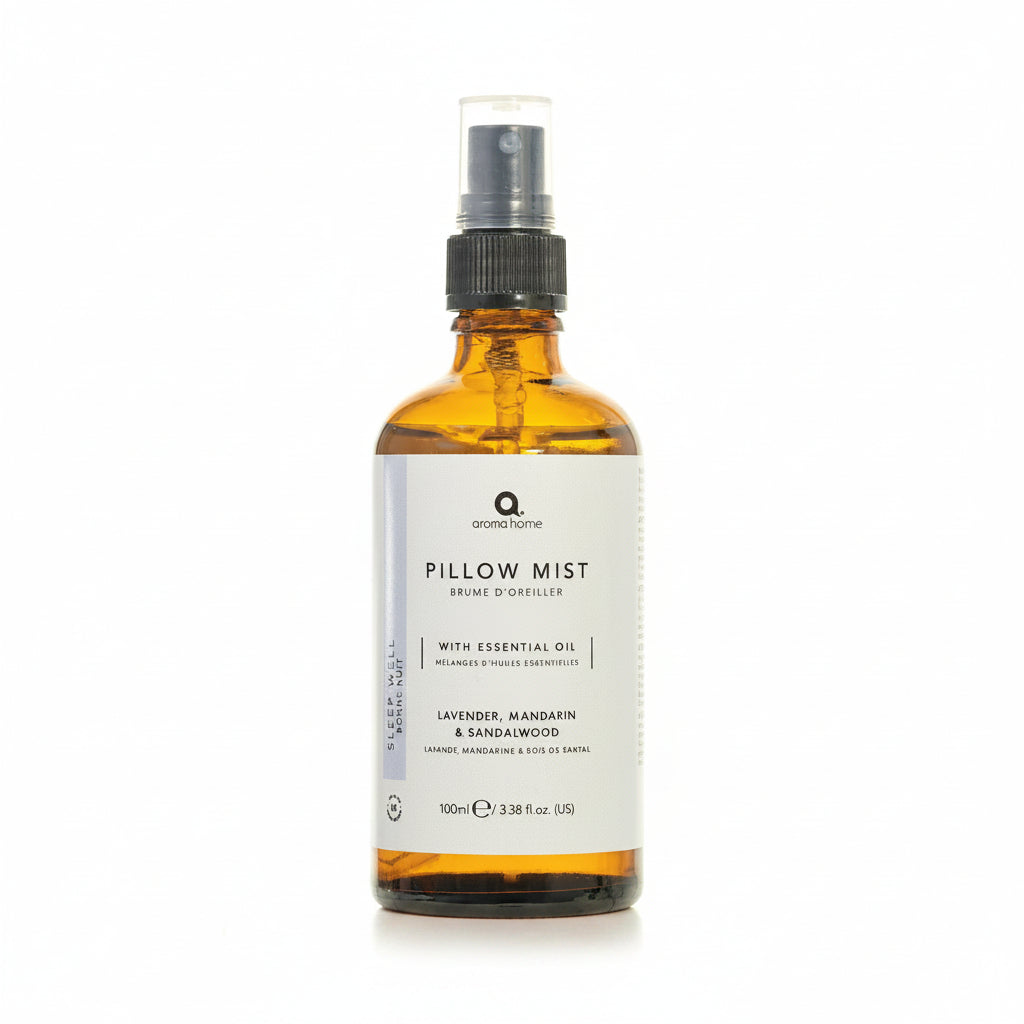 Aroma Home Sleep Well pillow mist in an amber glass bottle on a white background