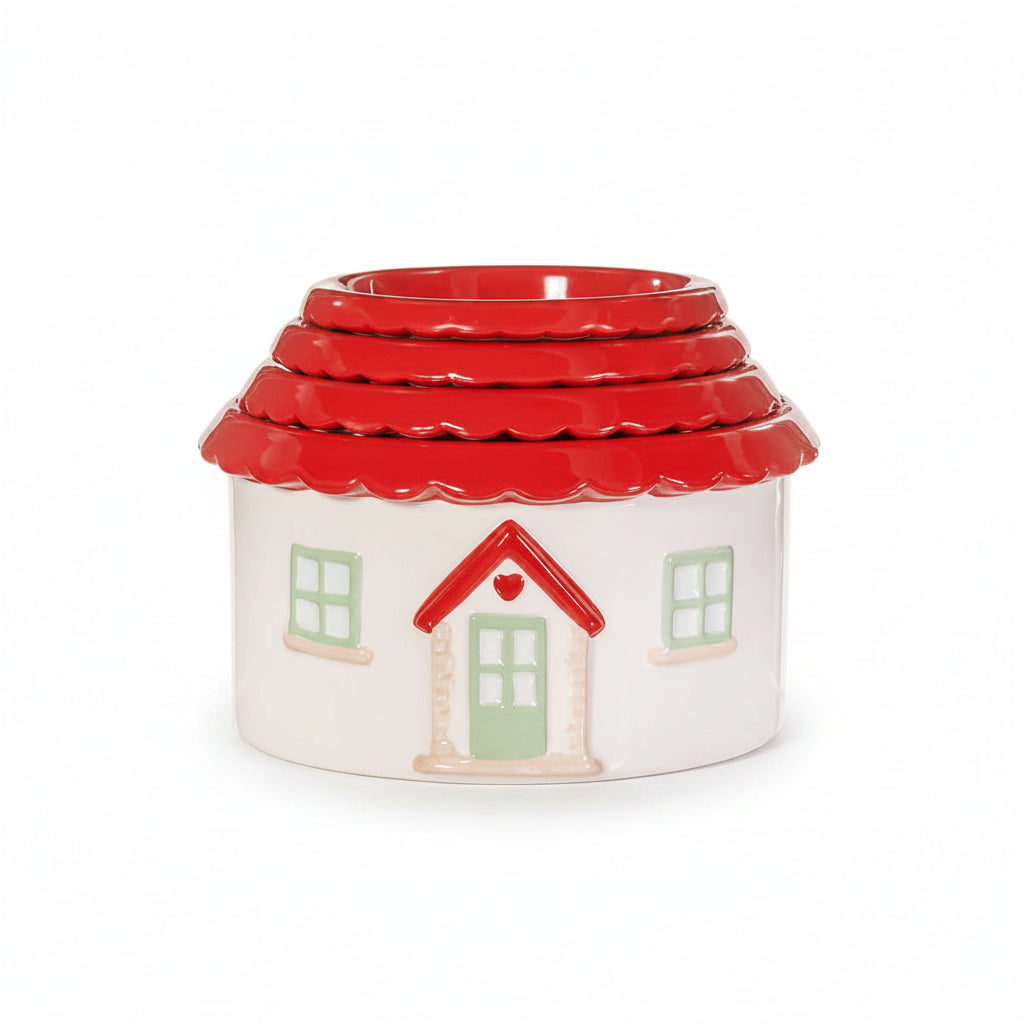 Close-up of house-shaped measuring cup showing red roof and white walls