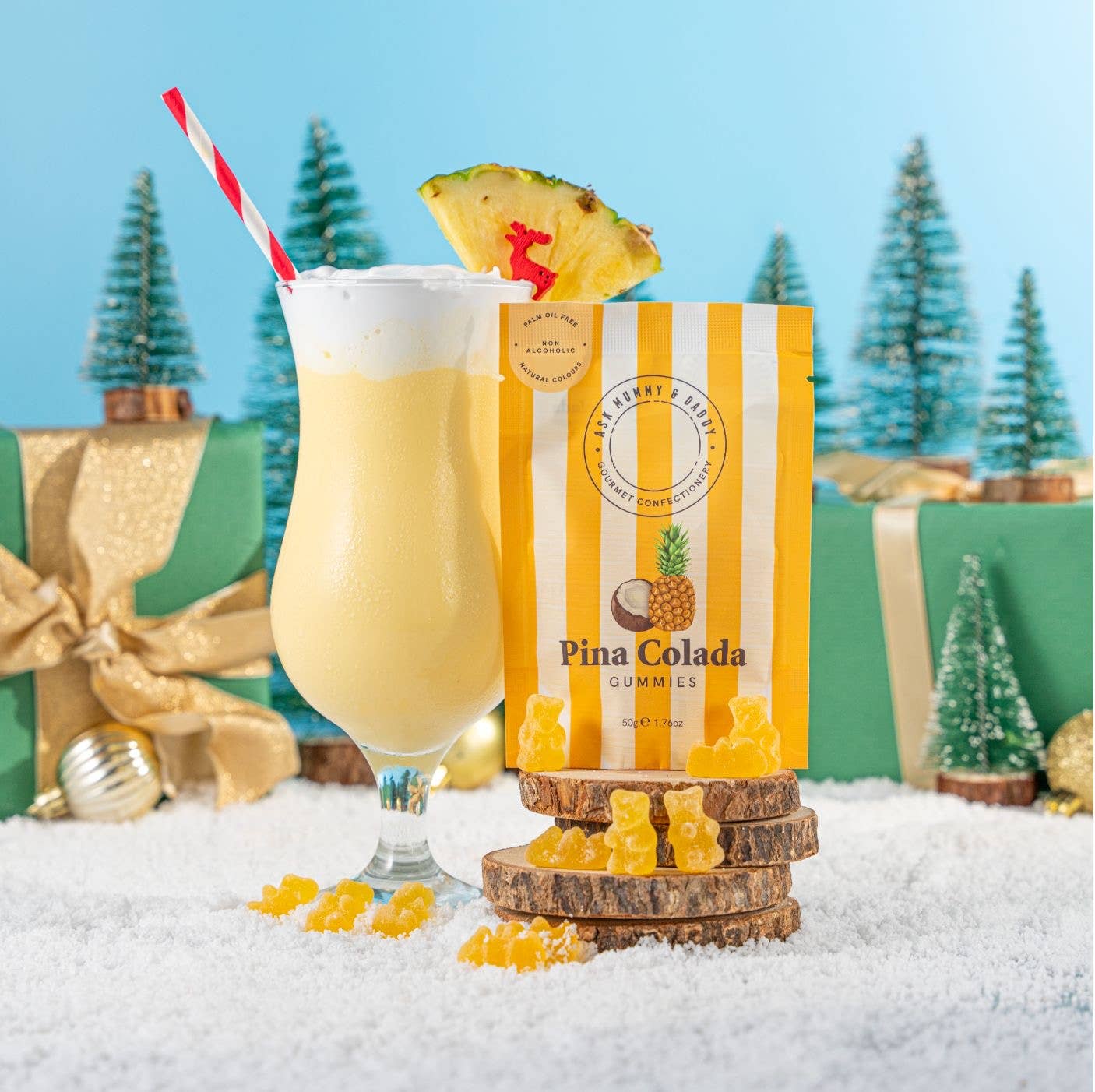 Pina Colada gummies pouch in a snowy Christmas scene with a cocktail