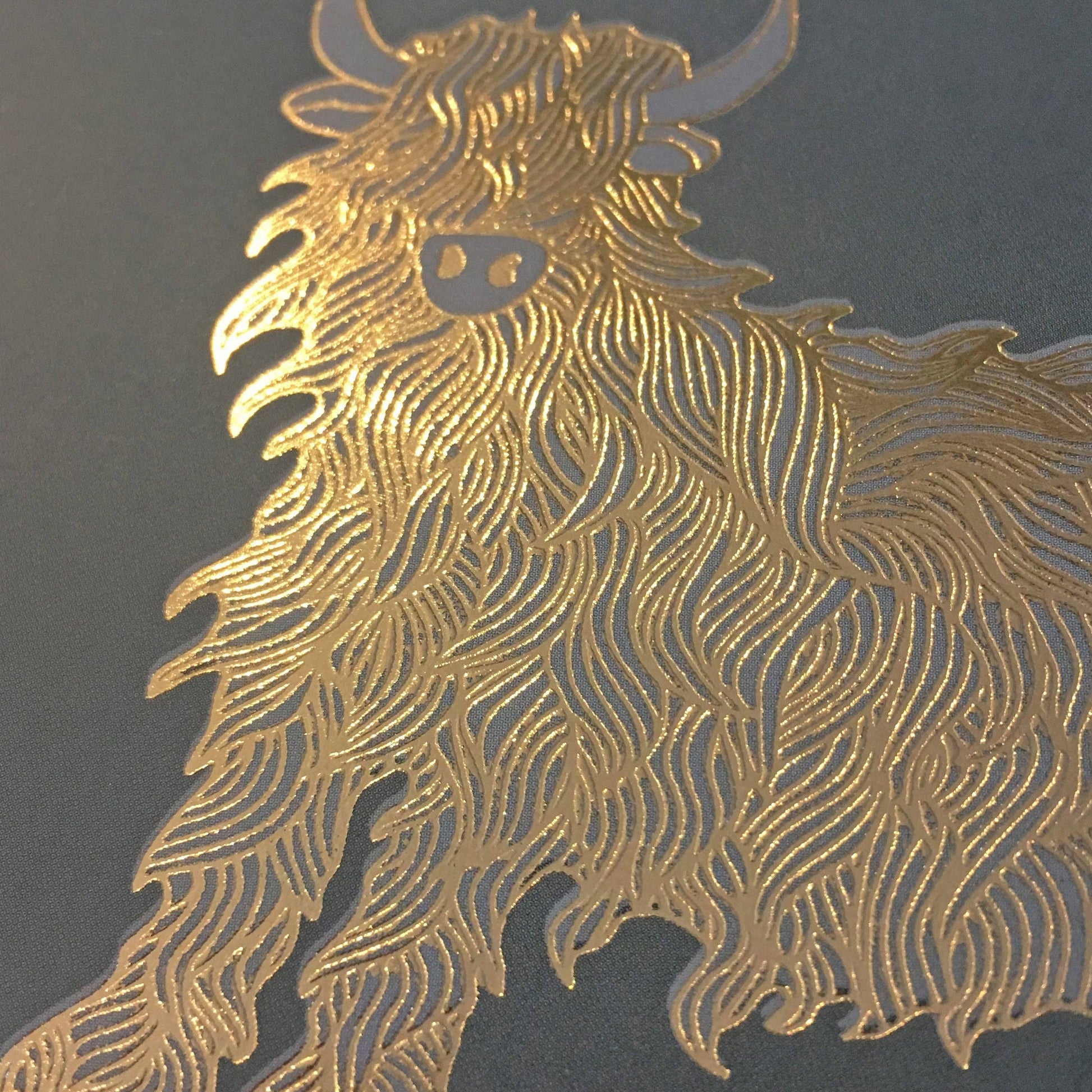 Close up of the gold foil Highland cow showing the shaggy coat detail