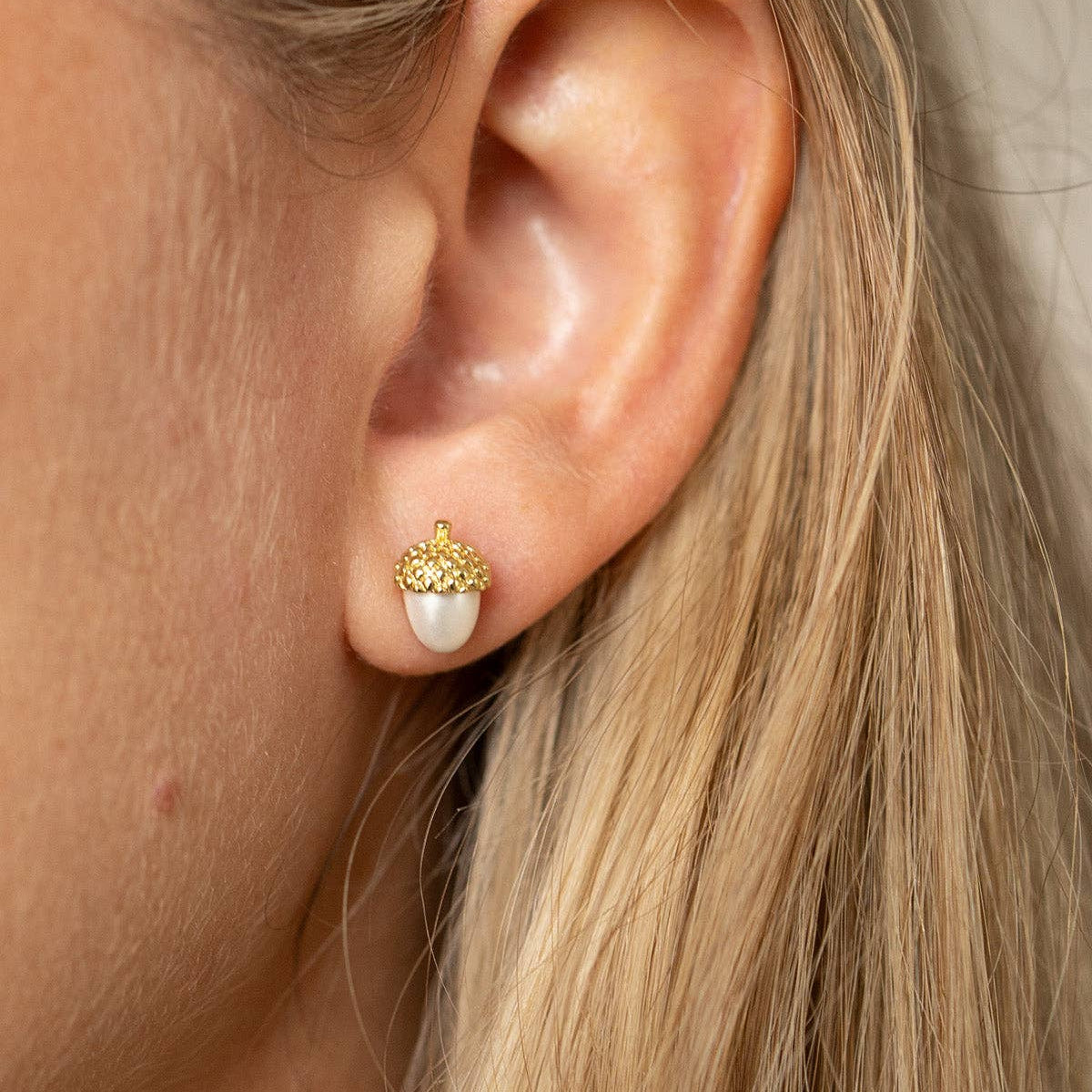 Acorn and Pearl Stud Earring worn, with long blonde hair