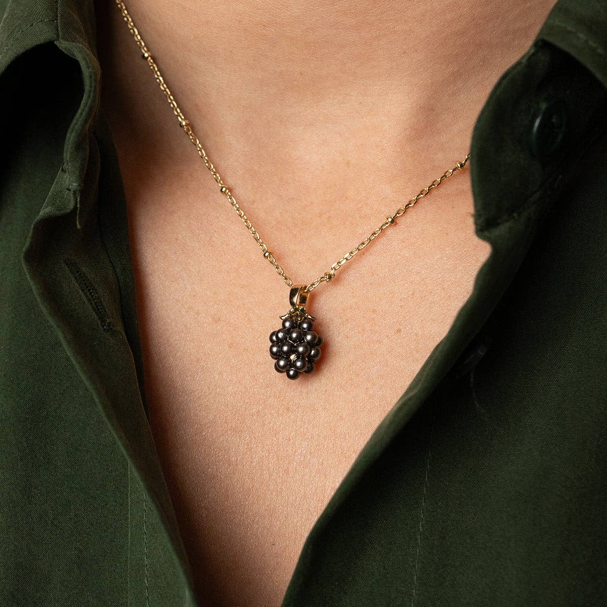 Blackberry Pendant necklace worn with a dark green shirt