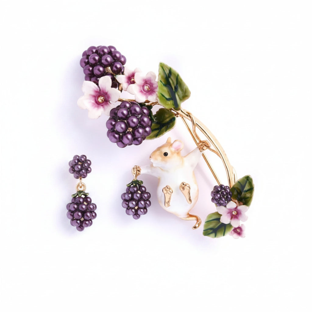 Close-up of Bill Skinner Blackberry & Mouse Brooch featuring hand-painted field mouse holding pearlised blackberries with enamel flowers.