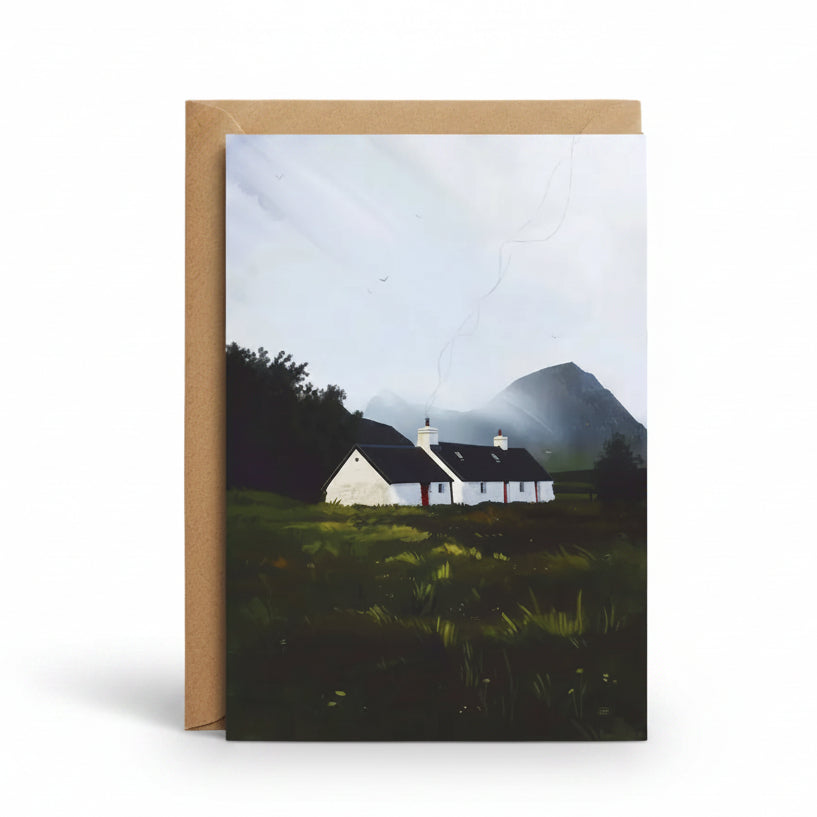 A vertical greeting card with a kraft paper envelope, featuring a landscape painting of a white cottage in a grassy field with dark trees and a mountain under a cloudy sky.