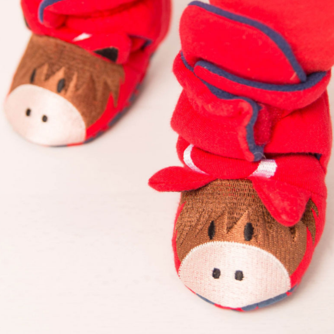 Close-up of the brown cow faces on red Hamish booties