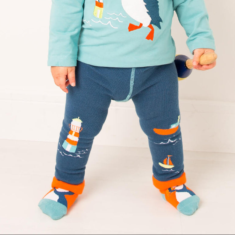 Toddler standing in the Kenzie the Puffin top, leggings and orange socks