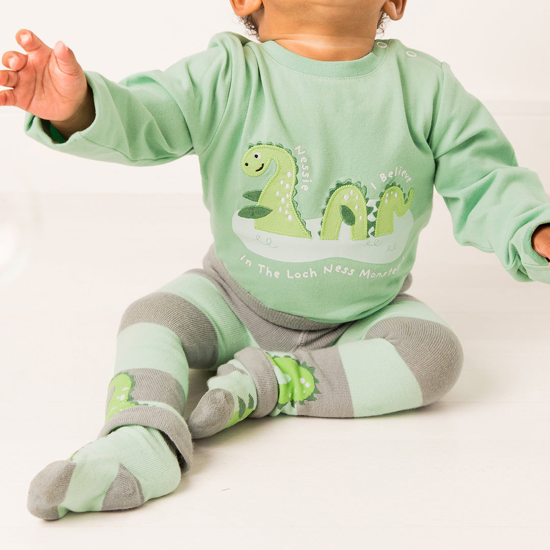 Baby seated in the full green Nessie top and leggings outfit