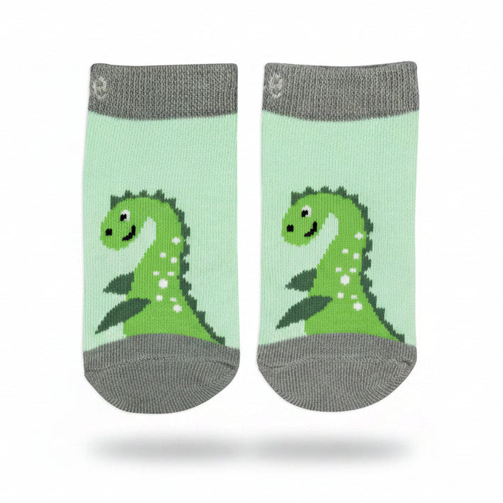 Pair of green and grey striped Nessie socks laid flat on a green background